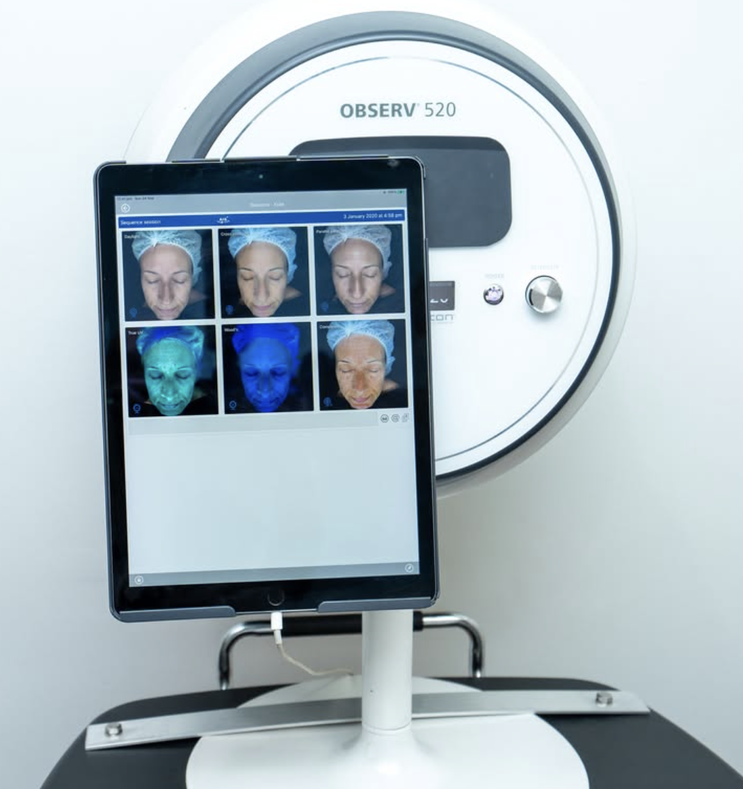 A dermal clinician performing an LED treatment
